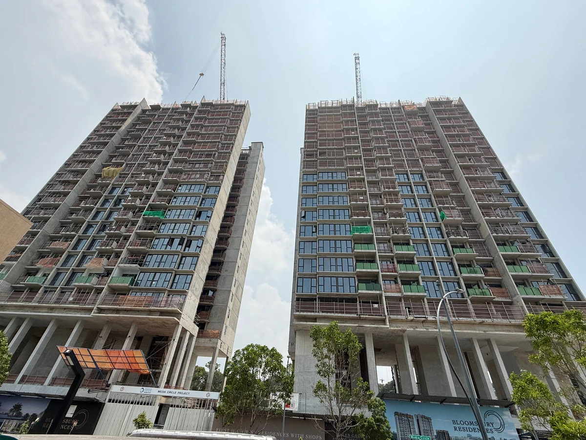 Actual site photo of Bloomsbury Residences towers under active construction along Media Circle dated 30 September 2026