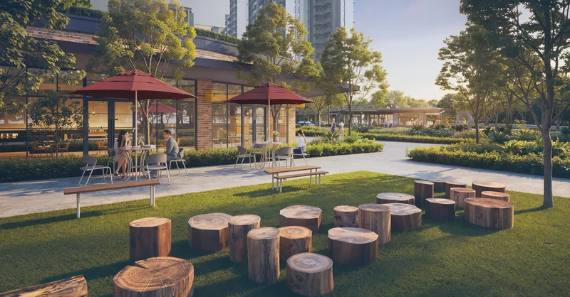 Hudson Place Residences retail promenade with alfresco cafe seating and landscaped park lawn