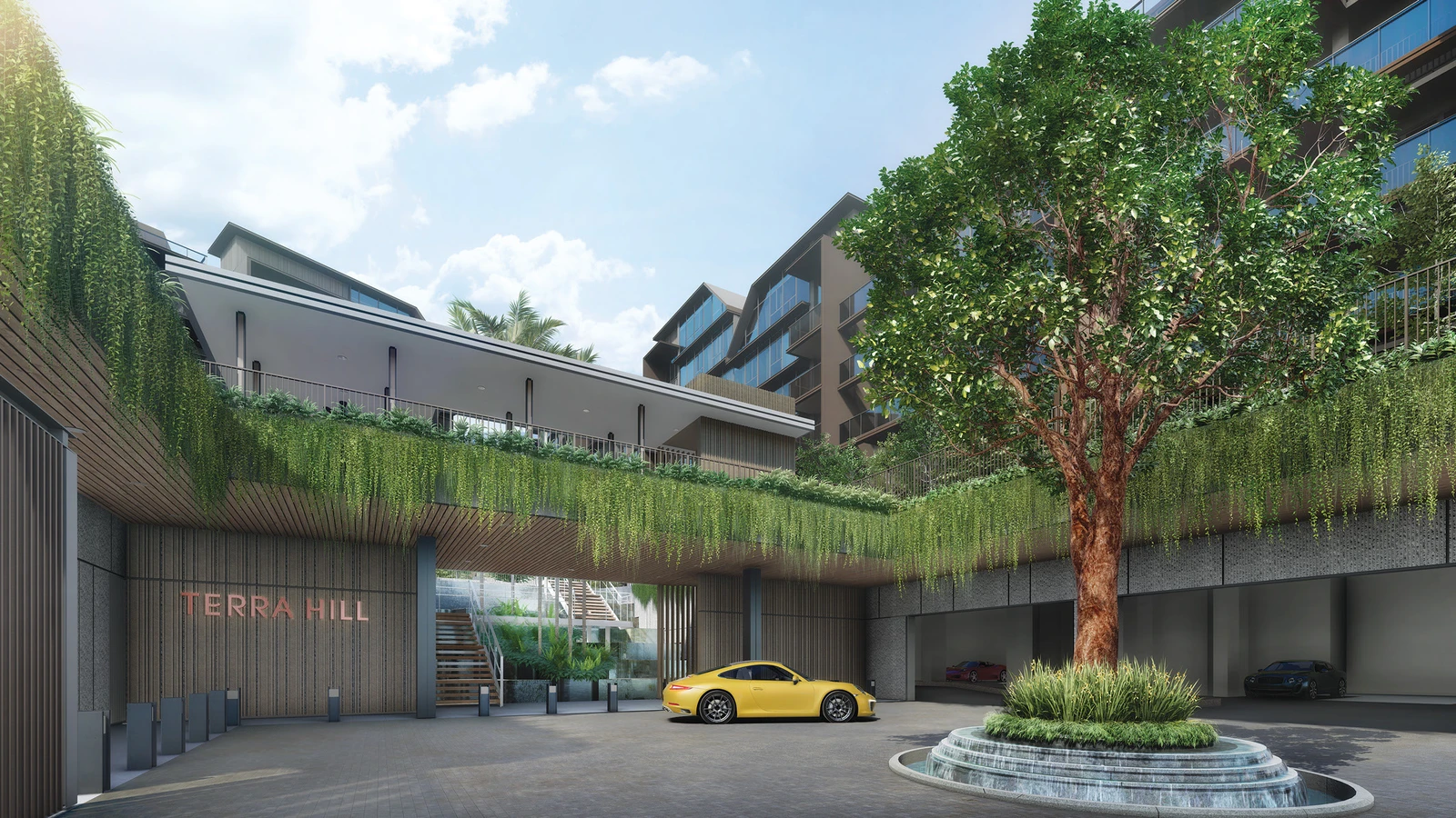 The grand arrival court and drop-off plaza at Terra Hill featuring cascading water features and lush greenery